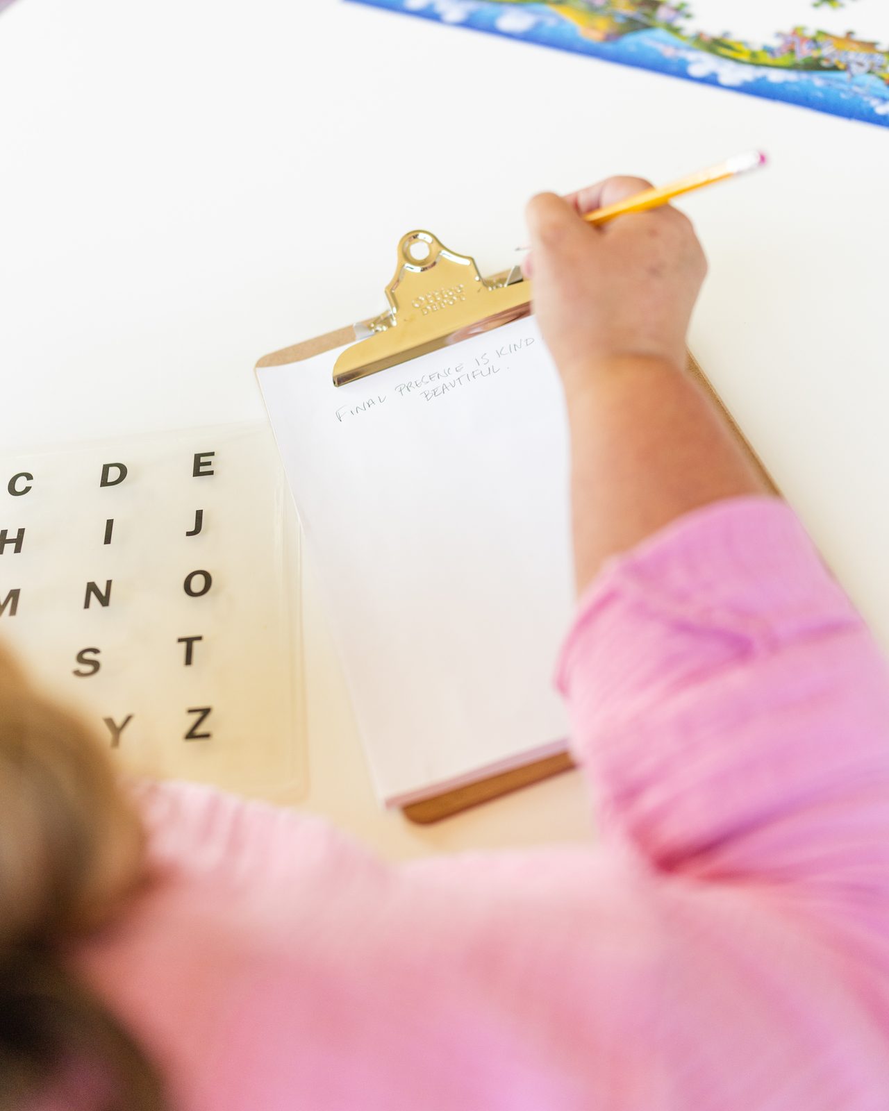 Writing down what was spelled on the letter board